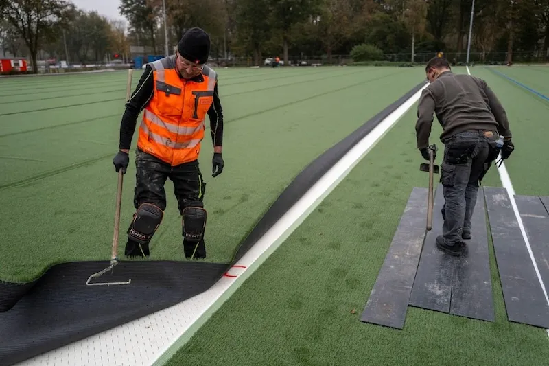 Shock pad installed underneath artificial sports turf