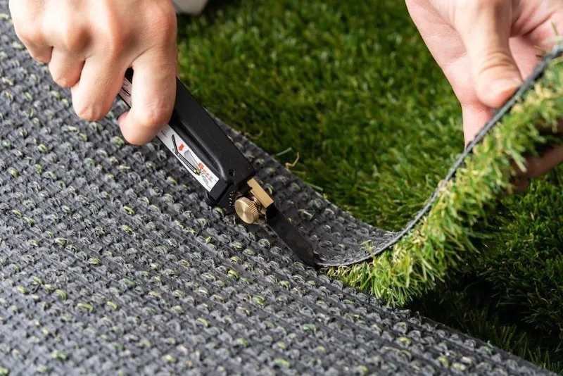 Use the utility knife to cut artificial turf