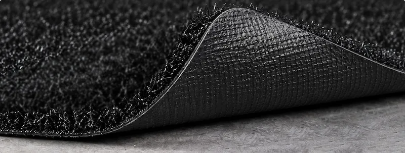 Close-up of smooth temporary-use backing on short-pile sled training turf.