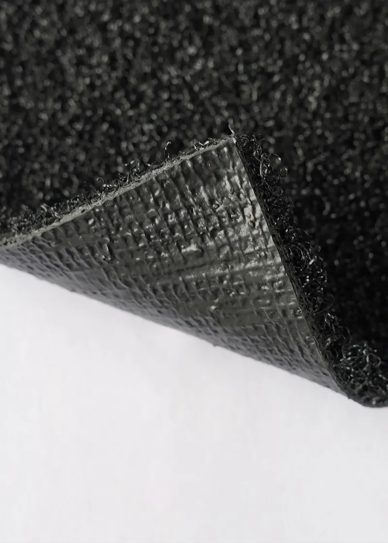 Close-up view of artificial turf backing construction.