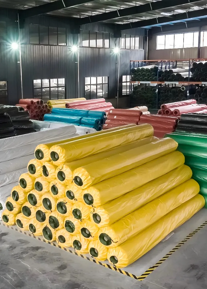 Finished artificial turf rolls prepared for packing and shipping.